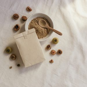 Botanical hair cleanser powder with ceramic bowl and reetha